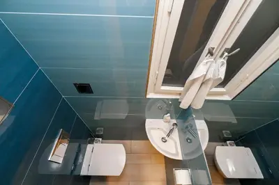 a bathroom with a sink and two toilets at LUXURY Apartment Dlouha in Prague