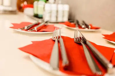 a table with red napkins and forks on it at Hotel Mandát in Hradištko