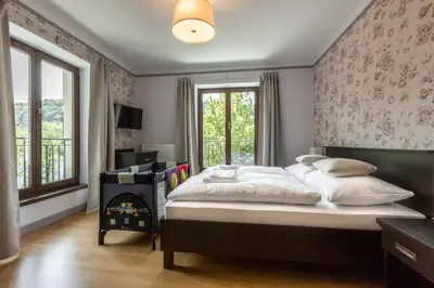 a bedroom with a large bed and a fireplace at Hotel Mandát in Hradištko