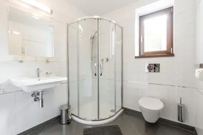 a bathroom with a shower and a sink and a toilet at Hotel Mandát in Hradištko