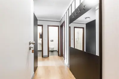 a hallway leading to a bathroom with black and white walls at Hotel Mandát in Hradištko