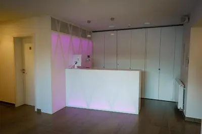 a large white wall in a room with white cabinets at Penzion Koráb in Prague