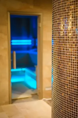 a room with a glass door with blue shelves at Penzion Koráb in Prague