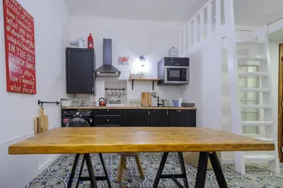 a kitchen with a wooden table in a room at Pinkova Apartments in Prague
