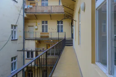 an empty hallway of an apartment building with balconies at Pinkova Apartments in Prague