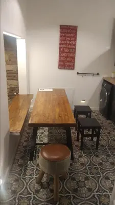a wooden table and a stool in a room at Pinkova Apartments in Prague