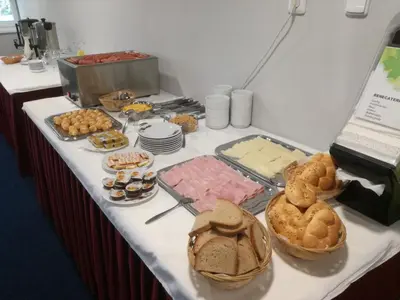 a table with different types of bread and pastries on it at Sporthotel Zimní stadion Benešov in Benešov