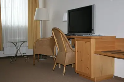 a room with a desk with a television and two chairs at Statek Malčany in Čím