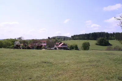a large field with a house in the distance at Statek Malčany in Čím