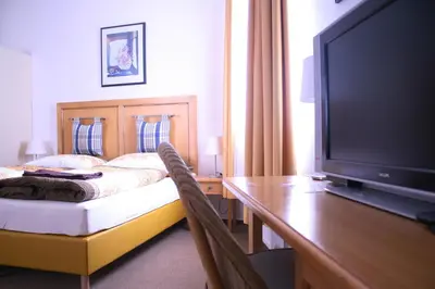 a bedroom with a bed and a flat screen tv at Statek Malčany in Čím