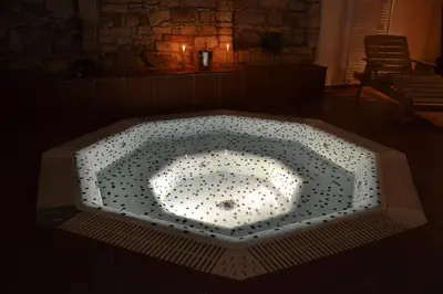 a large bath tub with lights in a room at Hejtmanský dvůr in Slaný