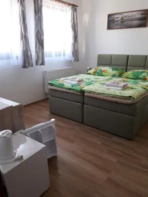 a bedroom with a bed in the middle of the room at Penzion Na Hrazi in Poděbrady