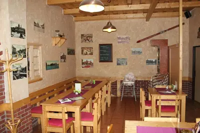 a dining room with wooden tables and chairs at Penzion Na Hrazi in Poděbrady