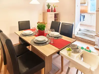 a dining room with a wooden table and chairs at Cozy Apartments with Terrace near Prague Castle in Prague