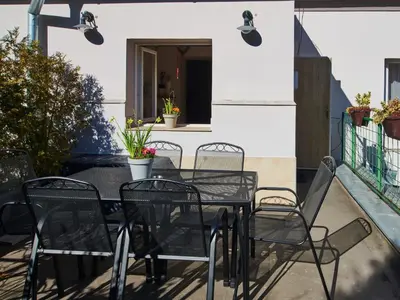 a black table and chairs on a patio at Cozy Apartments with Terrace near Prague Castle in Prague