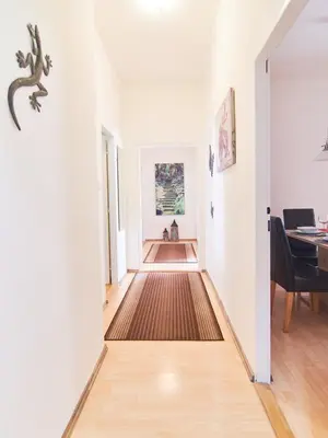 a hallway with white walls and a dining room with a table at Cozy Apartments with Terrace near Prague Castle in Prague