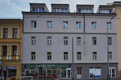 a large white building with windows on top of it at Cozy Apartments with Terrace near Prague Castle in Prague