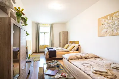 a living room with two beds and a couch at Cozy Apartments with Terrace near Prague Castle in Prague