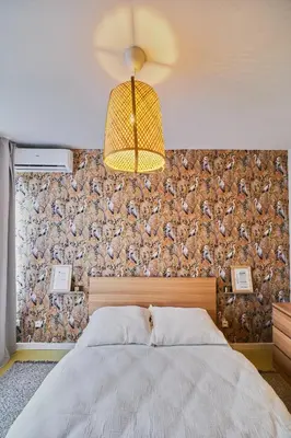 a bedroom with a large bed and a ceiling fan at Hostel Prazacka in Prague