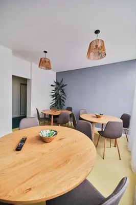 a conference room with wooden tables and chairs at Hostel Prazacka in Prague