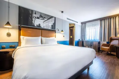 a large white bed in a hotel room at Radisson Blu Hotel Prague in Prague
