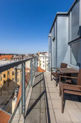 a balcony with chairs and tables on a building at Radisson Blu Hotel Prague in Prague