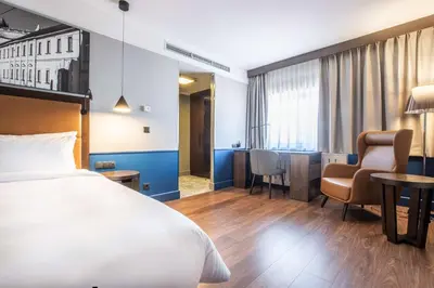 a hotel room with a bed and a desk at Radisson Blu Hotel Prague in Prague