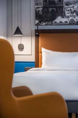 a bedroom with a bed and a picture on the wall at Radisson Blu Hotel Prague in Prague