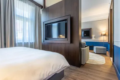 a hotel room with a bed and a tv at Radisson Blu Hotel Prague in Prague
