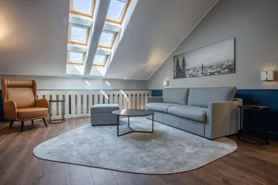 a living room with a couch and a chair at Radisson Blu Hotel Prague in Prague
