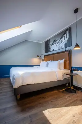 a bedroom with a large bed and a table at Radisson Blu Hotel Prague in Prague