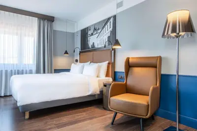 a hotel room with a bed and a chair at Radisson Blu Hotel Prague in Prague