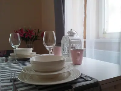 a table with plates and glasses on a table at NOT POSSIBLE TO BOOK !!! Apartment Vltavska B in Prague