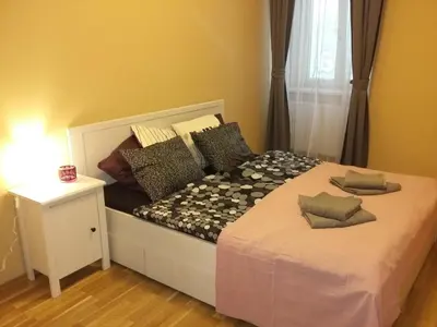 a bed with pillows on it in a room at NOT POSSIBLE TO BOOK !!! Apartment Vltavska B in Prague