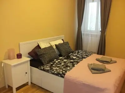 a bedroom with a bed with a white bed frame and a window at NOT POSSIBLE TO BOOK !!! Apartment Vltavska B in Prague