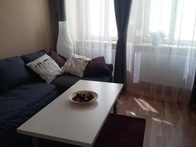 a living room with a couch and a bowl of fruit on a table at NOT POSSIBLE TO BOOK !!! Apartment Vltavska B in Prague