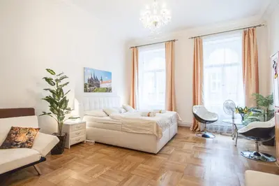 a white living room with a bed and a couch at Prague Palace - Wenceslas Square in Prague