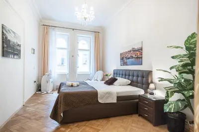 a bedroom with a bed and a potted plant at Prague Palace - Wenceslas Square in Prague