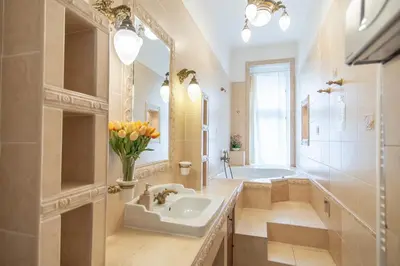 a bathroom with a sink and a tub and a mirror at Prague Palace - Wenceslas Square in Prague