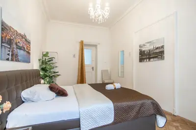 a bedroom with a bed and a chandelier at Prague Palace - Wenceslas Square in Prague