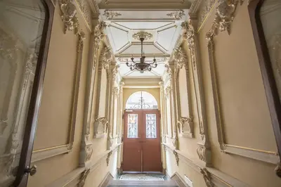 an empty hallway with a door and a chandelier at Prague Palace - Wenceslas Square in Prague