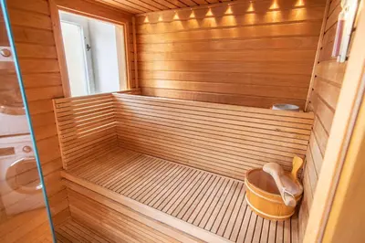 a wooden sauna with a bucket in the middle at Prague Palace - Wenceslas Square in Prague