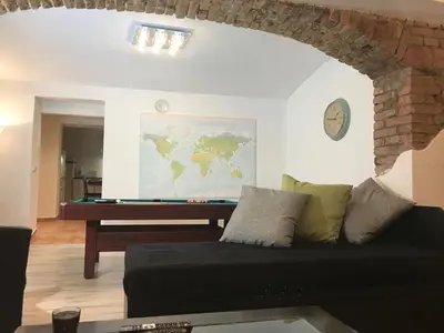 a living room with a couch and a table at Big Homebase with Billardtable in Prague