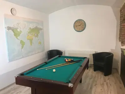 a room with a pool table and a clock on the wall at Big Homebase with Billardtable in Prague