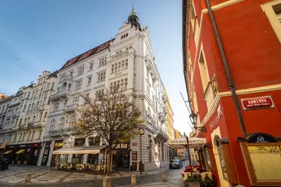 a tall white building with a statue on top of it at Royal Road Residence in Prague