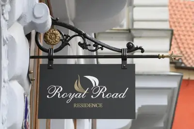 a sign for a royal road restaurant hanging on a building at Royal Road Residence in Prague
