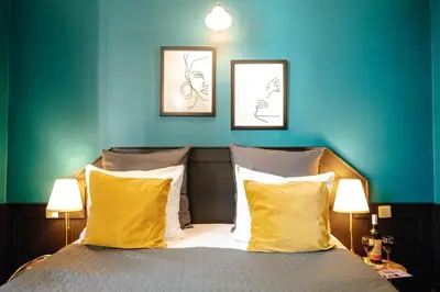 a couch with four pillows on it at Hotel Praga 1885 by Wagnerstays in Prague