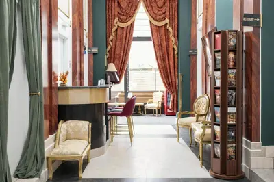 a living room with chairs and a fireplace at Hotel Praga 1885 by Wagnerstays in Prague