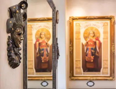 a mirror on a wall with two pictures of women at Hotel Caruso Old Town in Prague