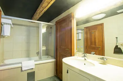 a bathroom with a sink and a tub and a mirror at Miss Sophie's Charles Bridge in Prague
